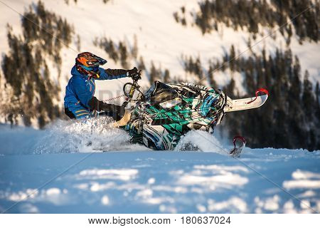 Rider on the snowmobile in the mountains ski resort in Amut Russia.