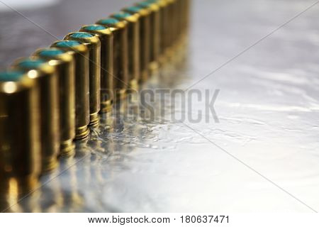 Metal brass gun hubs munitions on shiny silver desk