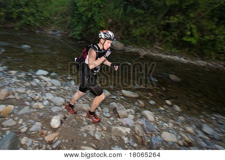 SABAH, MALEISIË - 2 APRIL. Een racer uit een deelnemende team maakt hun weg langs en over een ri