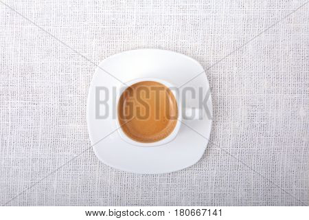 Classic espresso coffee in white cup isolated on white background. Top View