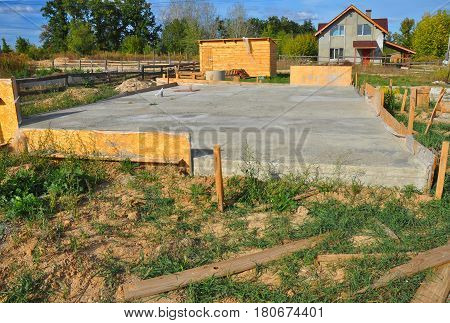 New Home Foundation Slab Construction with Reinforced Concrete and New Building House Exterior