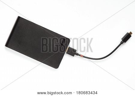 Black purbank with usb wire on a white background