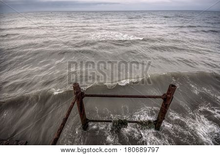 Sunset At The Sea Shore Of A Beach With Rocks And Stormy Waves, Beautiful Seascape At Caspian Sea Ab