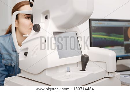 Eye testing equipment. Close up of medical equipment standing in the ophthalmologists office and being in use while checking the eyesight