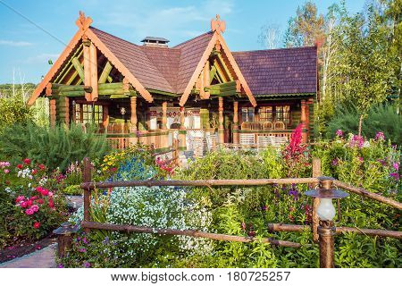 summer garden and wooden house on background