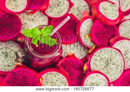 Smoothies Of Red Organic Dragon Fruit And Pieces Of Dragon Fruit On An Old Wooden Background