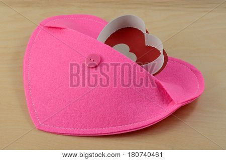 Heart emerging from pocket of larger pink heart