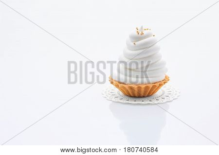 Mini meringue pie. Tart shell with white cream and sprinkles. Confectionery. Delicious dessert.