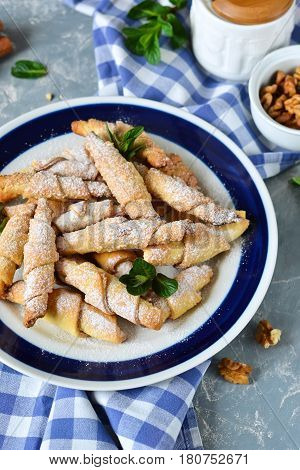 Sandwich rolls with cinnamon and sugar on a concrete background