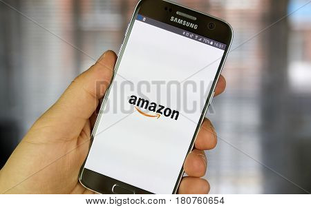 MONTREAL CANADA - MARCH 20 2017 - Amazon mobile application on screen of Samsung S5 in hand. Amazon is an American electronic commerce and cloud computing company.