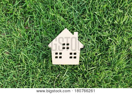 Wooden house on green grass / Eco house