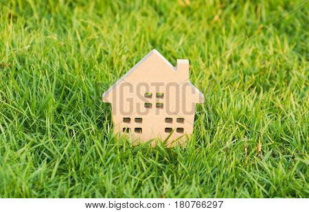 Wooden house on green grass / Eco house