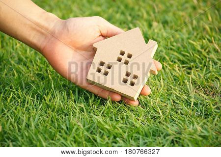 Wooden house on green grass / Eco house