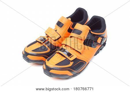 Mountain bike cycling shoes in orange color isolated