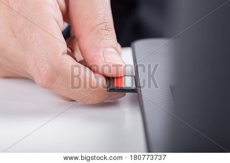 Hand Inserting Sd Card Into Laptop