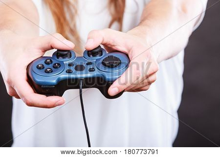 Playing games concept. Part body man with joystick play game on console playstation. Male hands holding grey pad.
