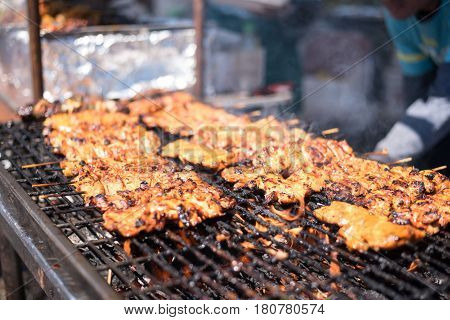 beef kabobs on grill with smoke and hickory wood