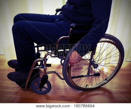 Elderly Man In A Wheelchair In The Room