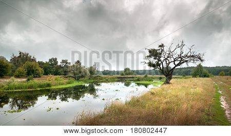 Cloudy sky over the river in autumn