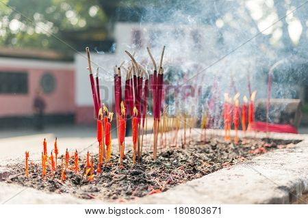Candles And Incense Sticks Burning In A Chinese Temple