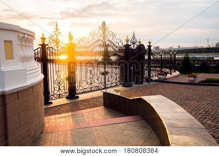 Golden city gate at sunset of day.