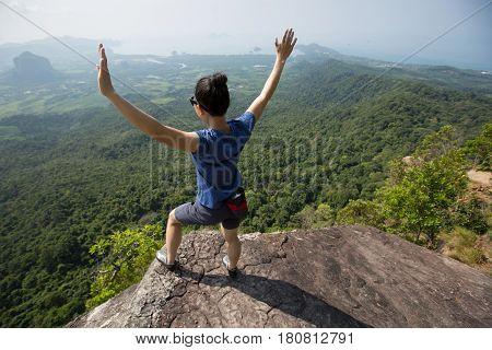 success young woman rock climber on mountain peak