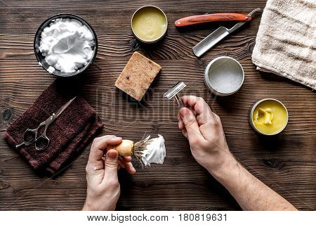 male hairdressing concept with barbershop hands and shaving tools set on wooden table background top view