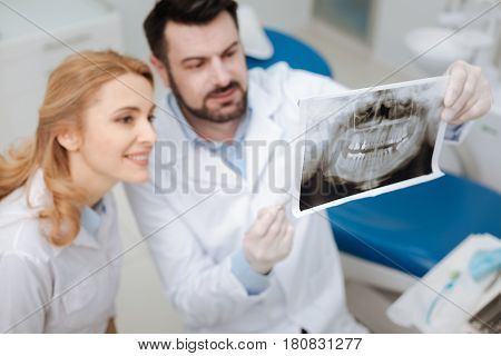 Do you spot this anomaly. Private capable competent dentist showing his future colleague scans of his patient explaining her some specifics and asking for her opinion
