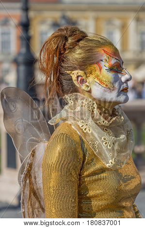 TIMISOARA ROMANIA - APRIL 1 2017: Living statue of a woman multicolor dressed and present on the street inside the CheckART Carnival organized by the City Hall Timisoara. Union Square.