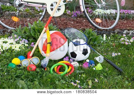 spring or summer with various outdoor fun equipment green meadow with a bicycle