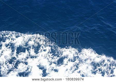 Dark blue water and sea spray, background