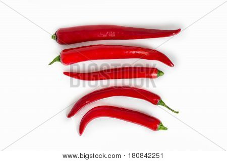 A pods of red hot pepper on a white background