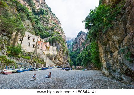 Furore Italy - June 30 2011: Tourists sitting in the fjord