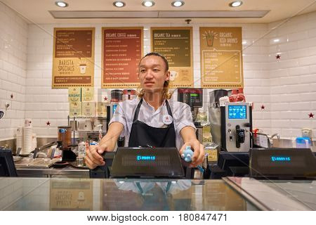 HONG KONG - CIRCA NOVEMBER, 2016: indoor portrait of a man at Pret a Manger in Hong Kong. Pret a Manger is a sandwich shop chain based in the United Kingdom.