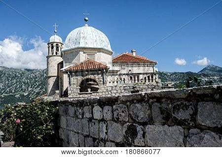 An old church in the background of the mountains