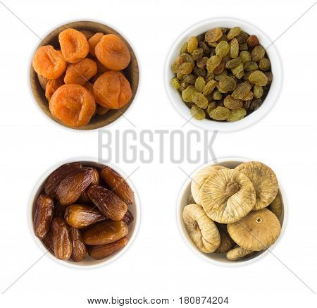 Collage of different dried fruits. Raisins dates dried apricots figs isolated on white background. Top view.
