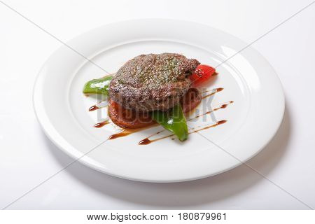 Grilled Steaks And Vegetables On A White Plate