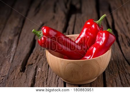Red chilly pepper on wooden black background. Red hot chili peppers. Domestic cultivation extra hot chilli burn.