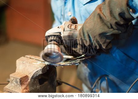 Making Of Horseshoe. Male Worker Polishing Horseshoe.