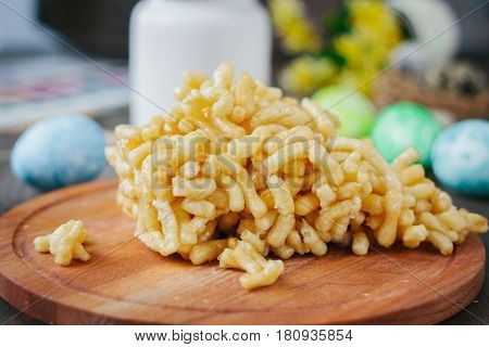 Chak-chak Cake Over Wooden Board Surrounded By Easter Eggs.