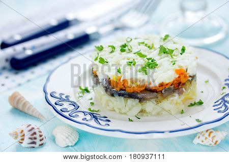 Layered salad with salted fish and boiled vegetables