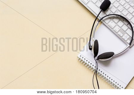 manager office desk with headset and keyboard on brown background top view mockup