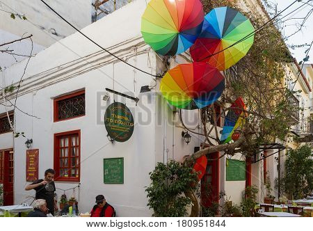 People Sitting Outside A Traditional Tavern Restaurant In Nafplion, Greece