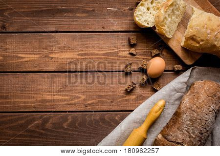 Baking fresh homemade bread on wooden kitchen table background top view moke up