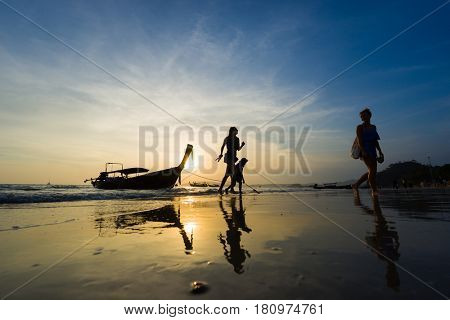 Ao Nang Krabi Thailand - March 03 2017: People on the Ao Nang beach at sunset in Krabi province Thailand