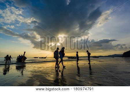 Ao Nang Krabi Thailand - March 02 2017: People on the Ao Nang beach at sunset in Krabi province Thailand