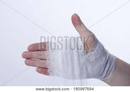 White medical dressing on a traumatized female hand