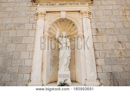 Ancient statue on the territory of the Church of the Nativity of Our Lady in Prcanj, Montenegro