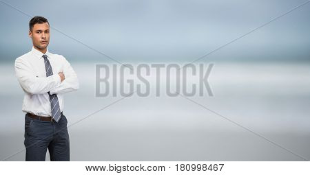 Digital composite of serious business men with hands folded and blue blurred background