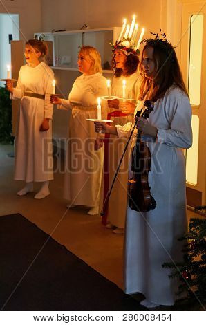 Stockholm, Sweden - Dec 13, 2018: Lucia Parade With Singing Girls In White Dresses Holding Candles. 